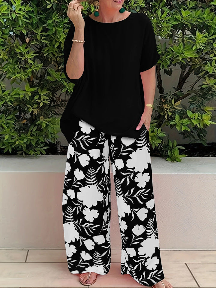 Isolde two-piece set: black blouse with short sleeves and black floral wide-leg pants