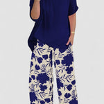 Isolde two-piece set: navy blouse with short sleeves and floral wide-leg pants