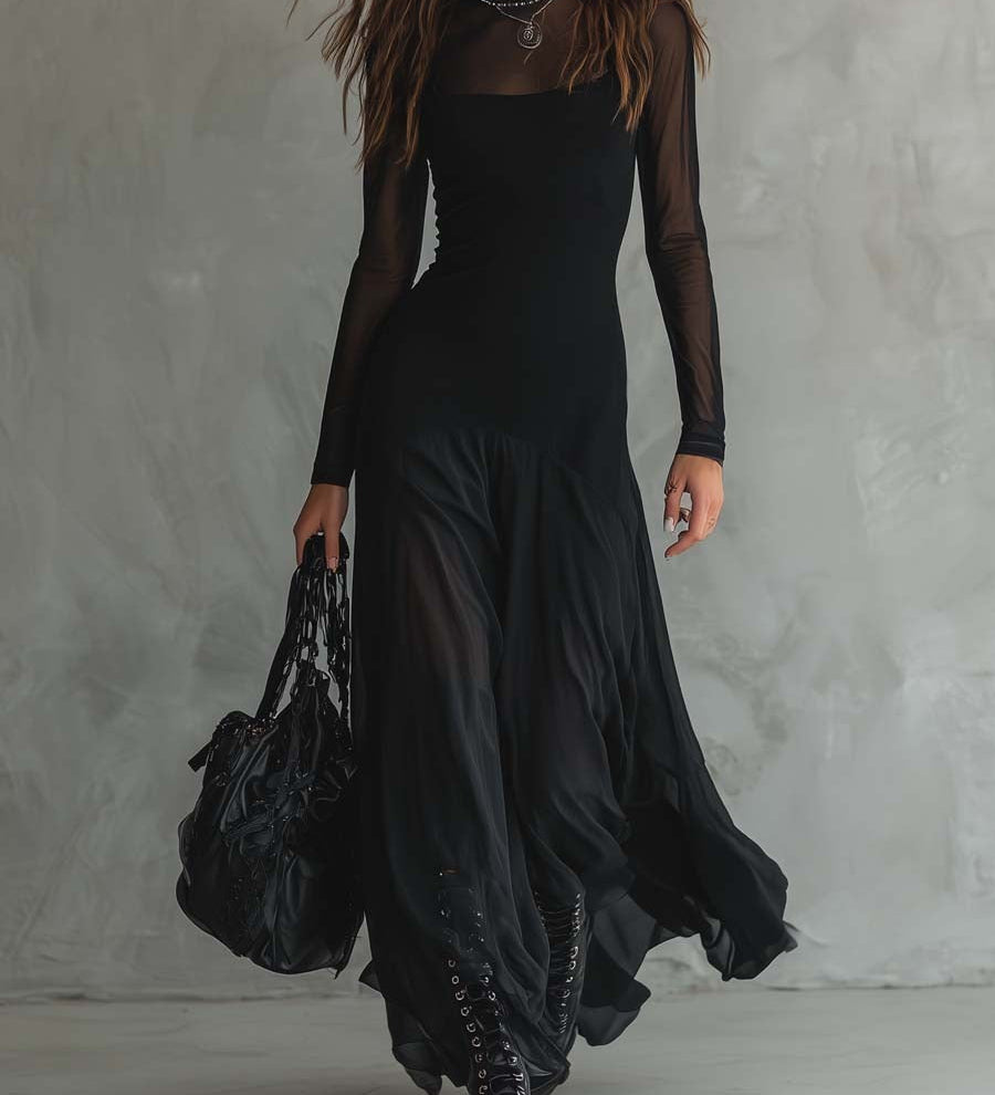 Long black dress with fitted bodice, sheer sleeves, and draped layered hem