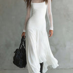 Long white dress with sheer long sleeves and flowing layered skirt