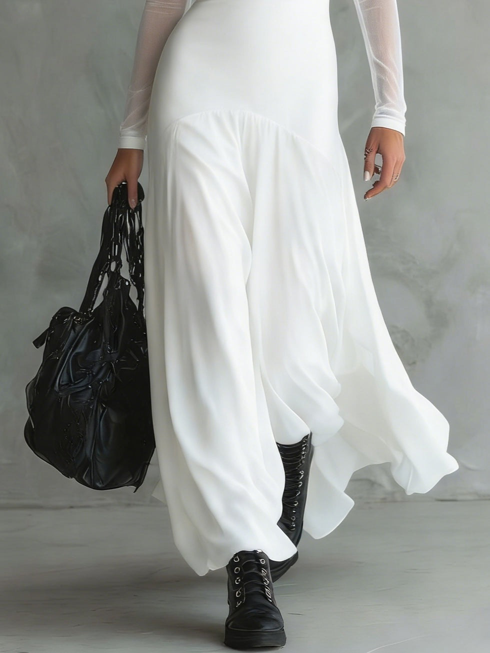 Long white dress with fitted bodice, sheer sleeves, and layered ankle-length hem