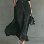 Long dark green pleated maxi dress with buttoned V-neck and high-waist gathers