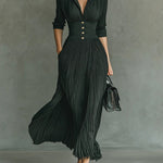 Green long pleated dress with lapels, high waist, button front, and short sleeves.