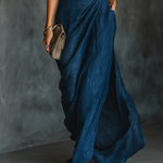 Blue wrap-style wide-leg trousers with textured fabric and ruched high waist