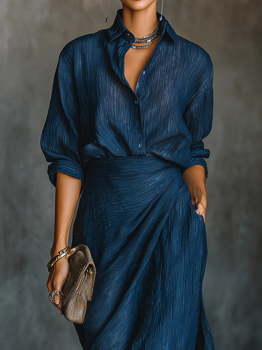 Blue button-front blouse with V-neck and draped waist over wide-leg trousers