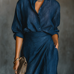 Blue button-front blouse with V-neck and draped waist over wide-leg trousers