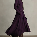 Side view of purple asymmetric draped long dress with cowl neck and long sleeves