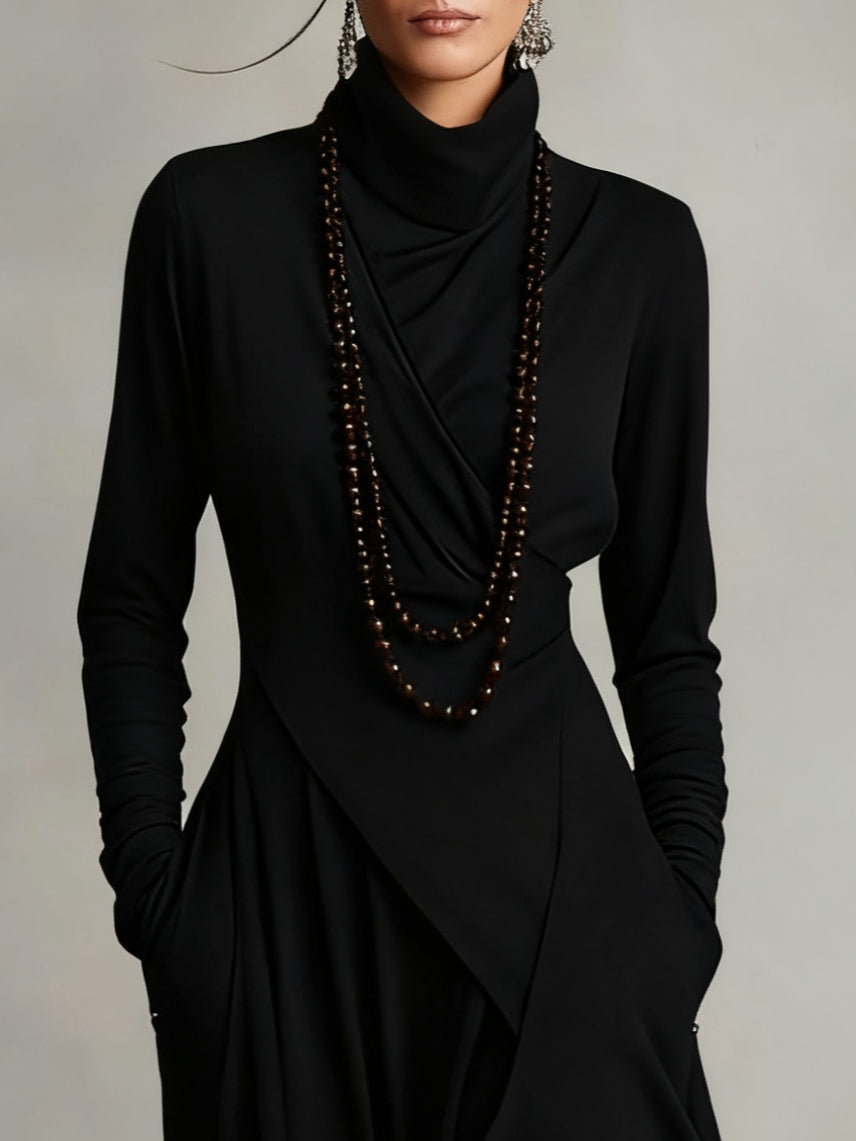 Close-up of black asymmetric draped long dress with cowl neck and long sleeves