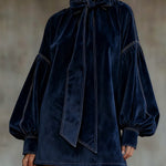 Blue velvet mini dress with bow tie neck, long puff sleeves, stitched detail
