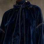 Blue velvet mini dress with large bow tie and long puff sleeves, stitched trim