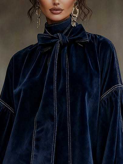 Blue velvet mini dress with large bow tie and long puff sleeves, stitched trim