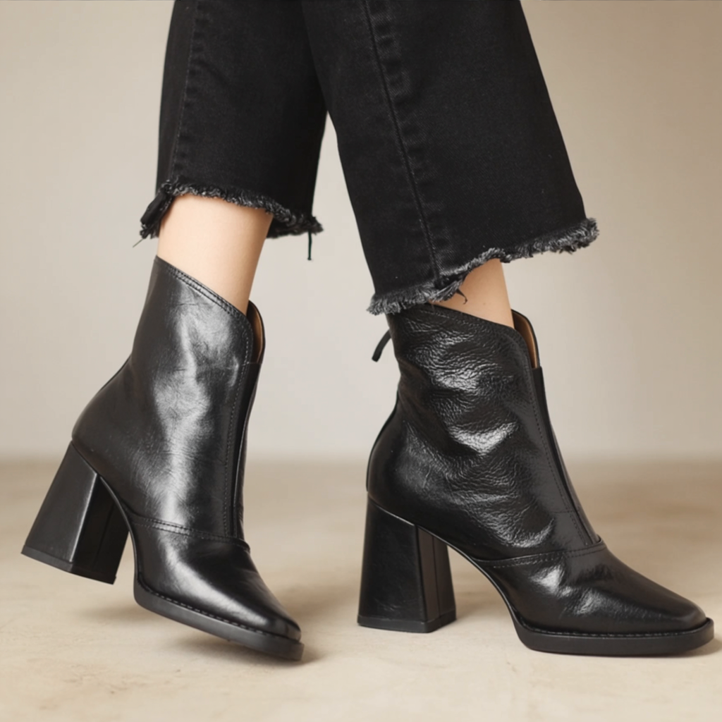 Black ankle boots with medium block heel and pointed toe, side zip closure