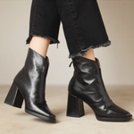 Black ankle boots with medium block heel and pointed toe, side zip closure