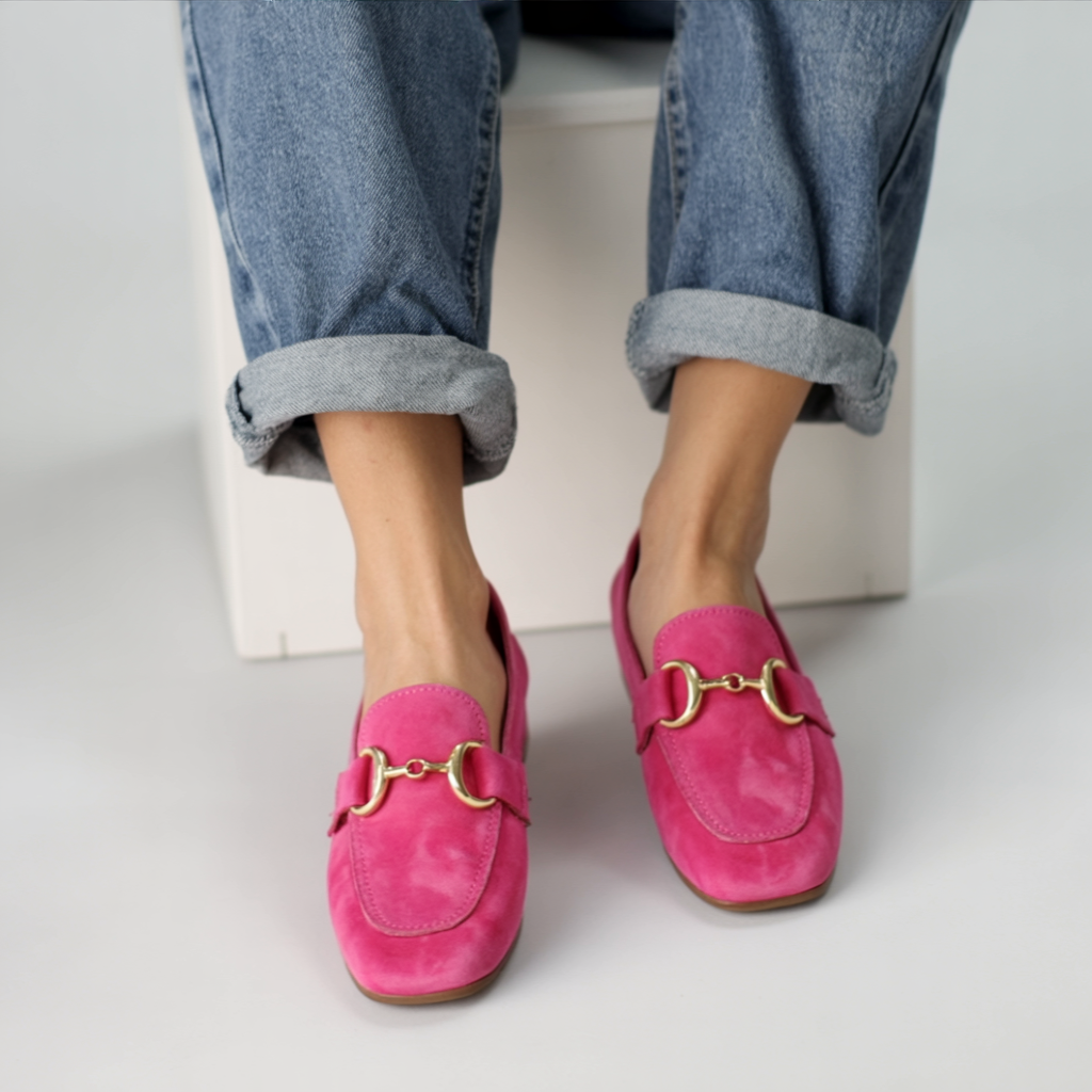 Women’s pink slip-on moccasins with gold hardware detail, rounded toe
