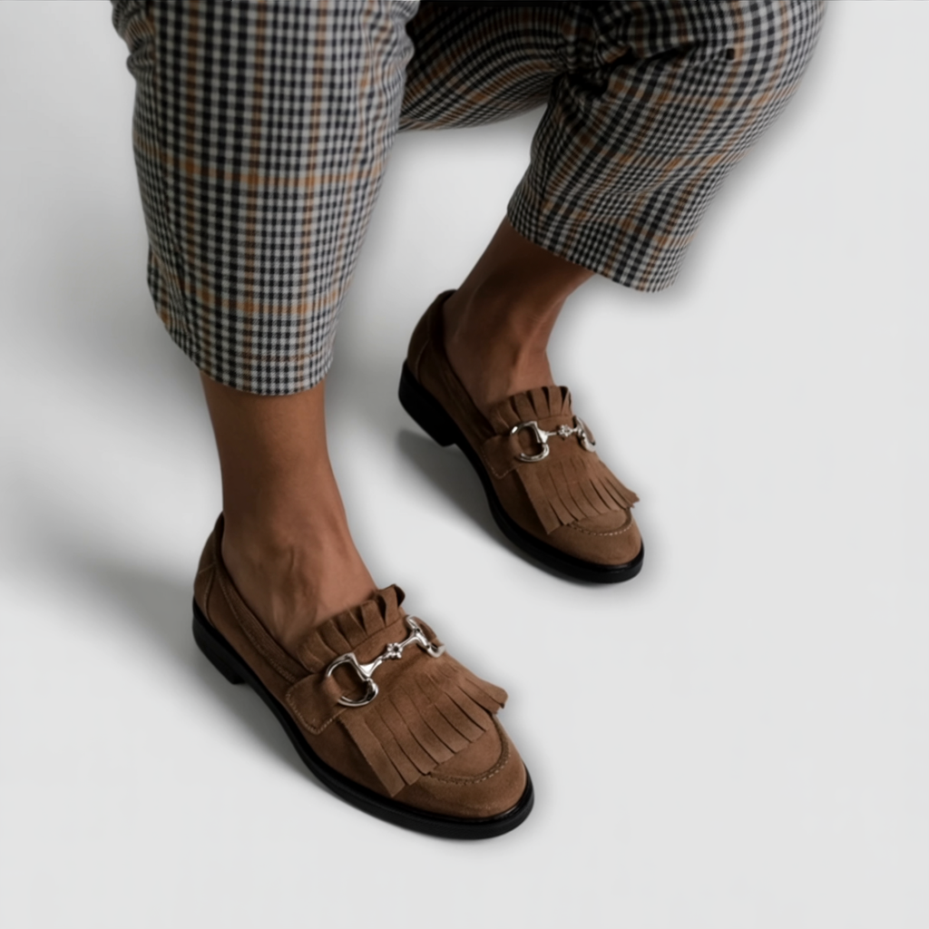 Pair of brown suede moccasin shoes, round toe, fringe detail, metal buckle strap