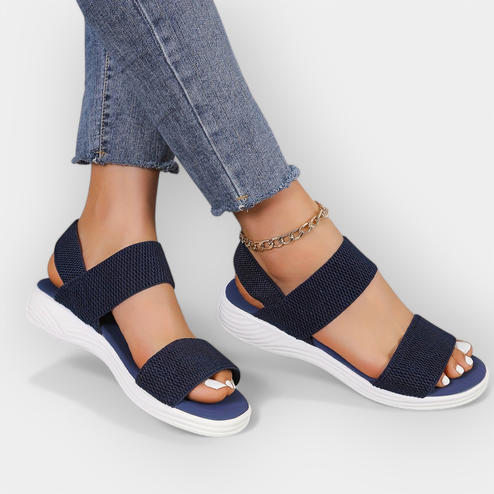 Comfort sandals with adjustable wide straps, open toe, dark navy knit upper, white platform sole.