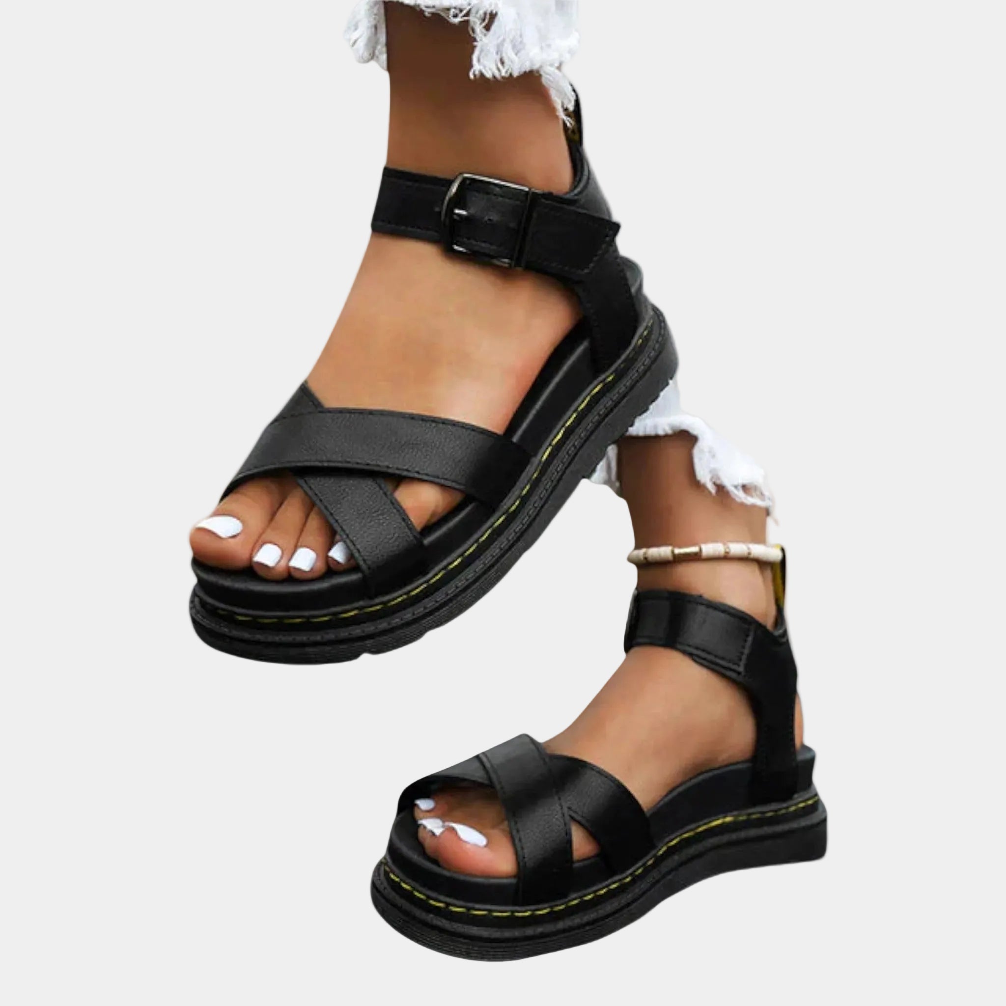 Black comfort sandals with two straps and buckle, chunky sole with yellow stitching