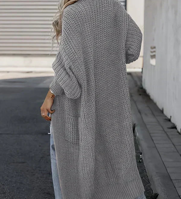 Light gray long knit cardigan, back view, loose fit with ribbed cuffs and side pockets