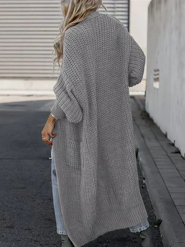 Light gray long knit cardigan, back view, loose fit with ribbed cuffs and side pockets