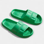 Lightweight slide sandals in green, padded strap and ridged footbed, pair view