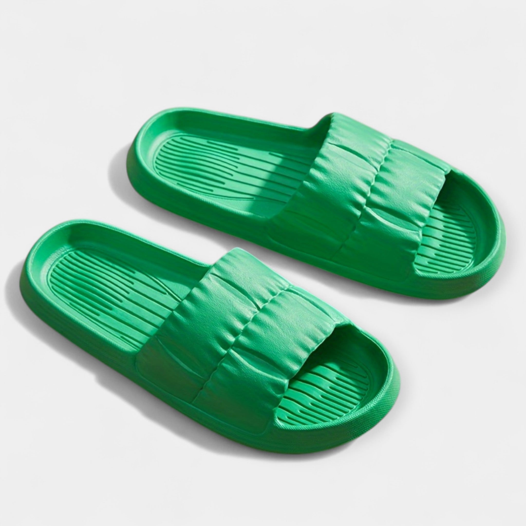 Lightweight slide sandals in green, padded strap and ridged footbed, pair view