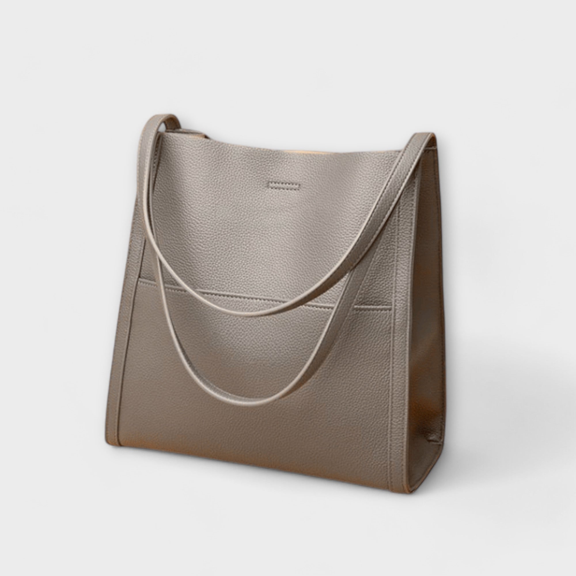 Beige taupe natural leather tote bag with curved strap handles and front tab detail