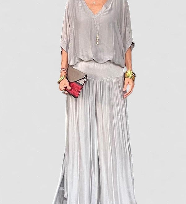 Two-piece chiffon set with draped blouse and wide-leg pants, light gray-silver.