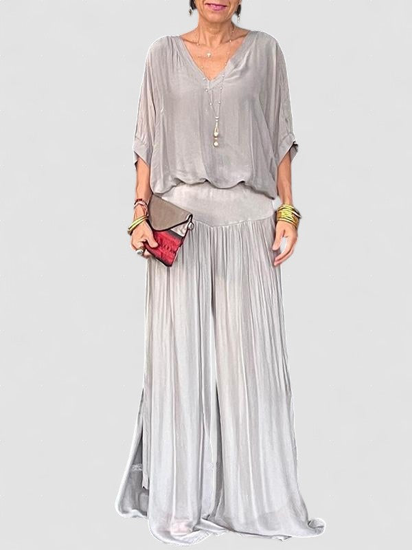 Two-piece chiffon set with draped blouse and wide-leg pants, light gray-silver.