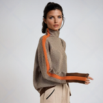 High-neck striped sweater with orange side panels and ribbed cuffs, chevron pattern