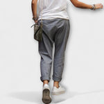 Dark gray wide-leg pants with cuffed ankles and side pockets.