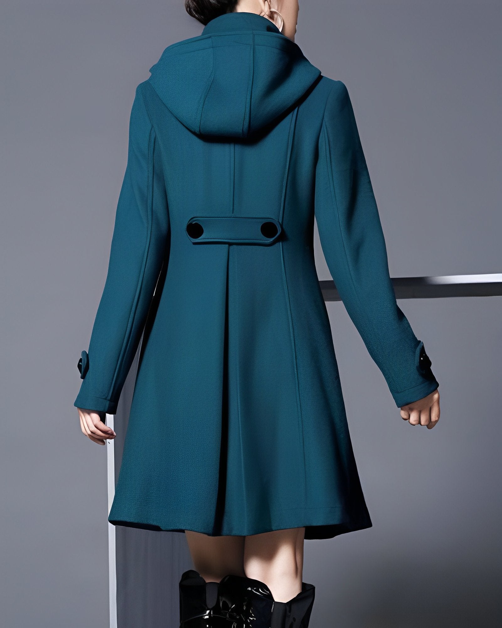Women’s teal hooded coat, back view with center yoke and belt-like waist tab