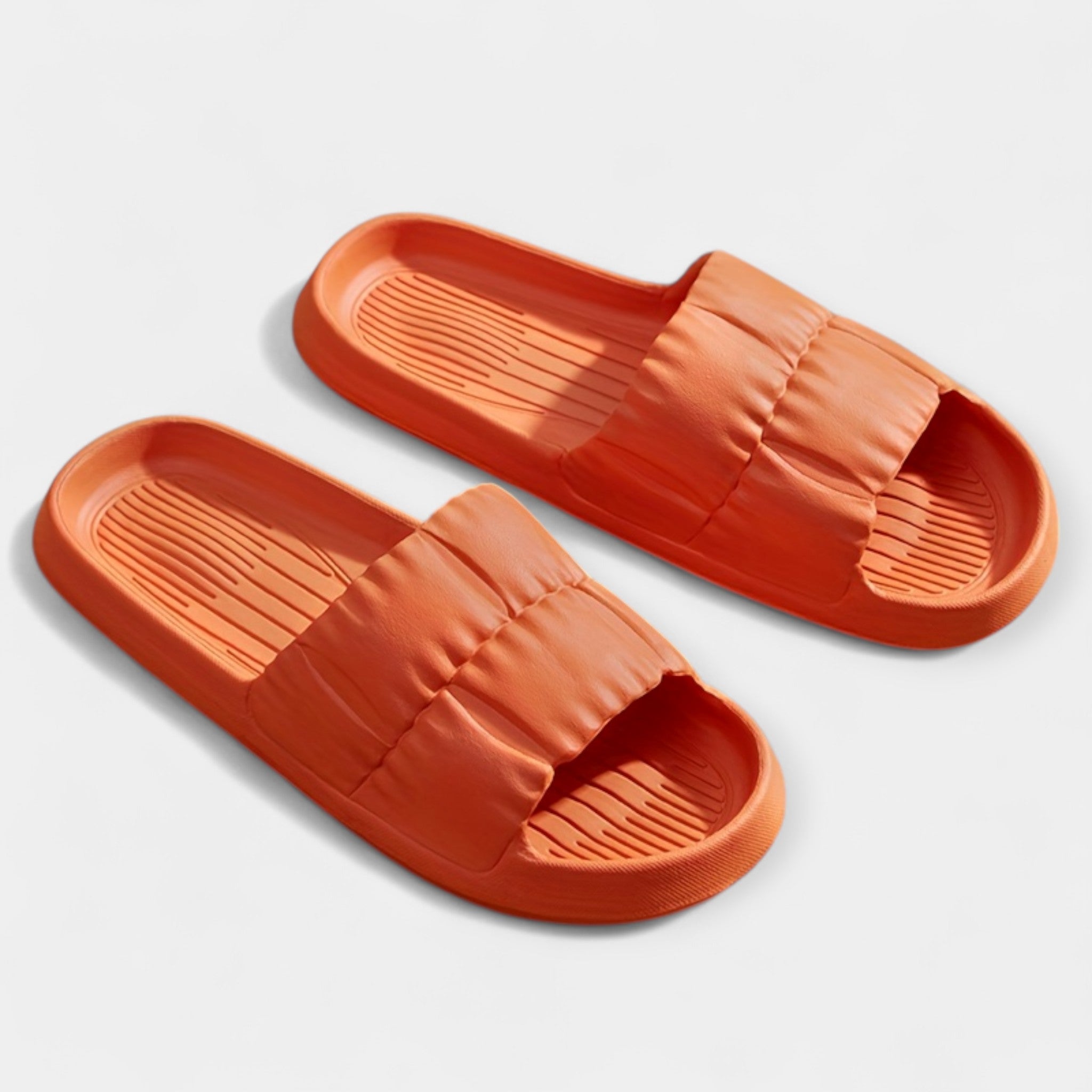 Lightweight slide sandals in orange, padded strap and ridged footbed, pair view