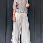 Two-piece chiffon set with V-neck blouse and flowy wide-leg pants, light gray.