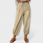 Beige harem pants with elastic waist and side cargo pockets