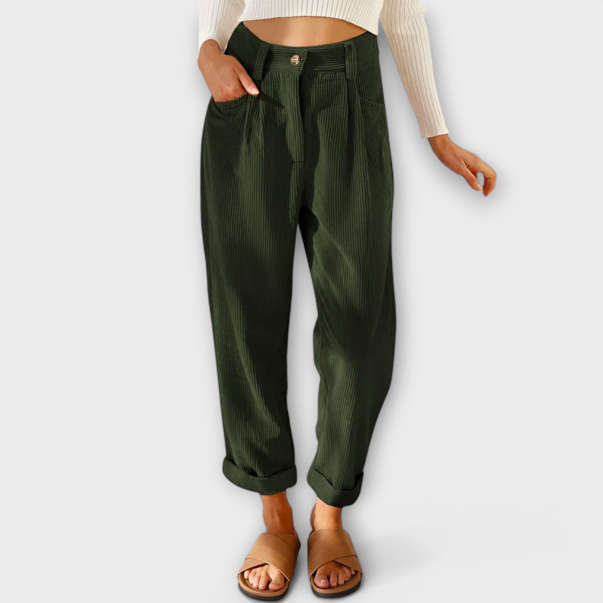 Cropped dark green pants with pleats, button fly, and side pockets