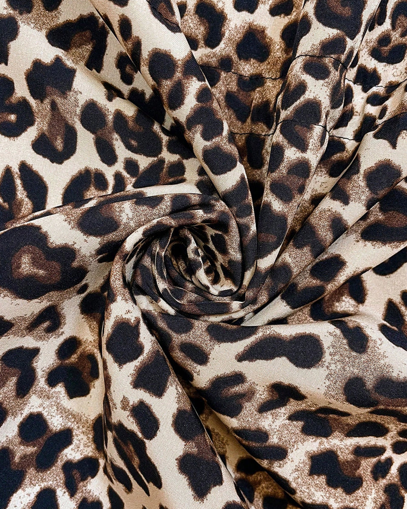 Leopard-print jacket fabric close-up with ruched tie-knot detail