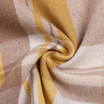 Close-up of yellow and tan plaid shirt fabric with soft woven texture