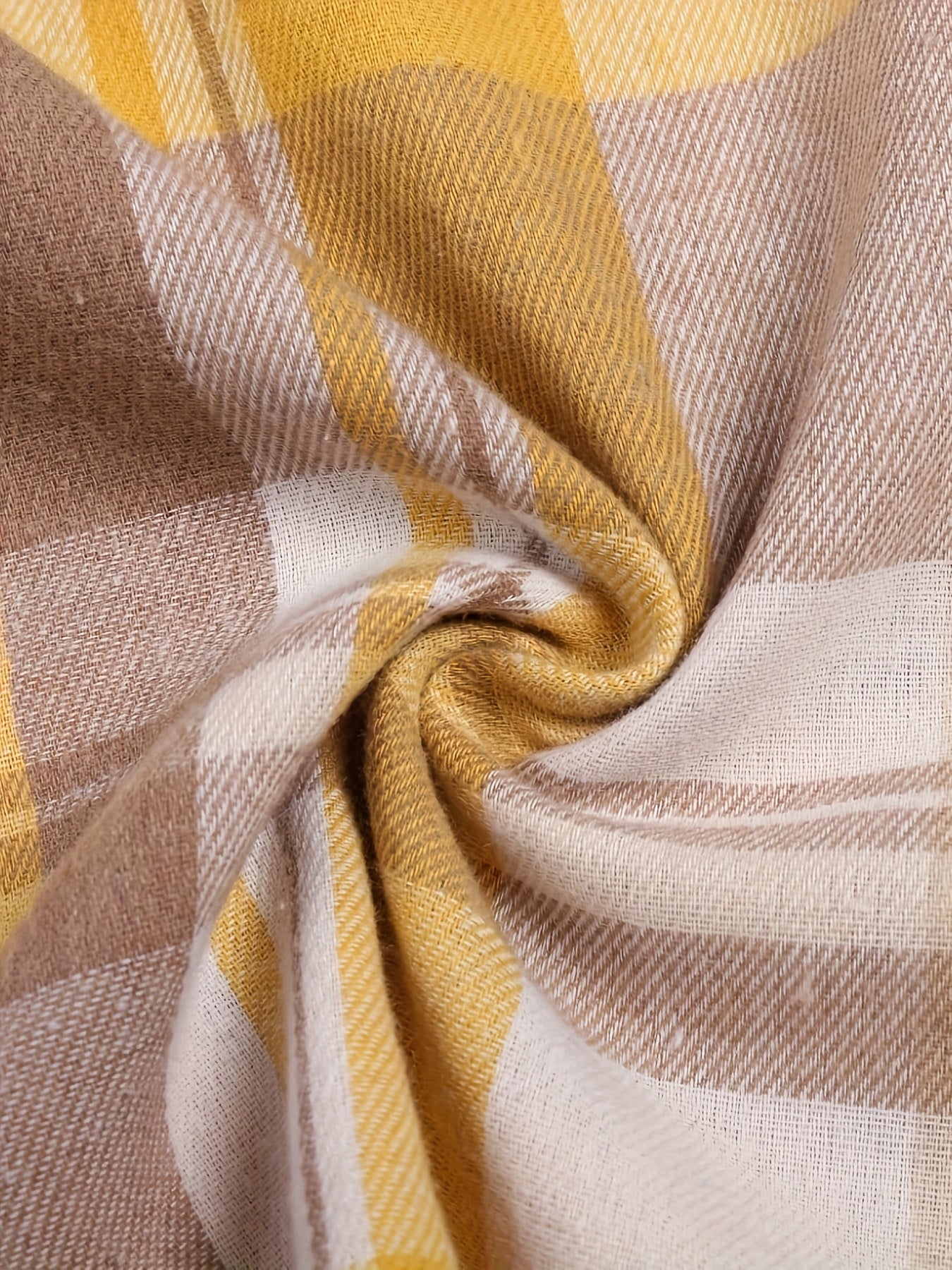 Close-up of yellow and tan plaid shirt fabric with soft woven texture