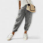 Comfort striped pants in black with light vertical pinstripes, cuffed hems