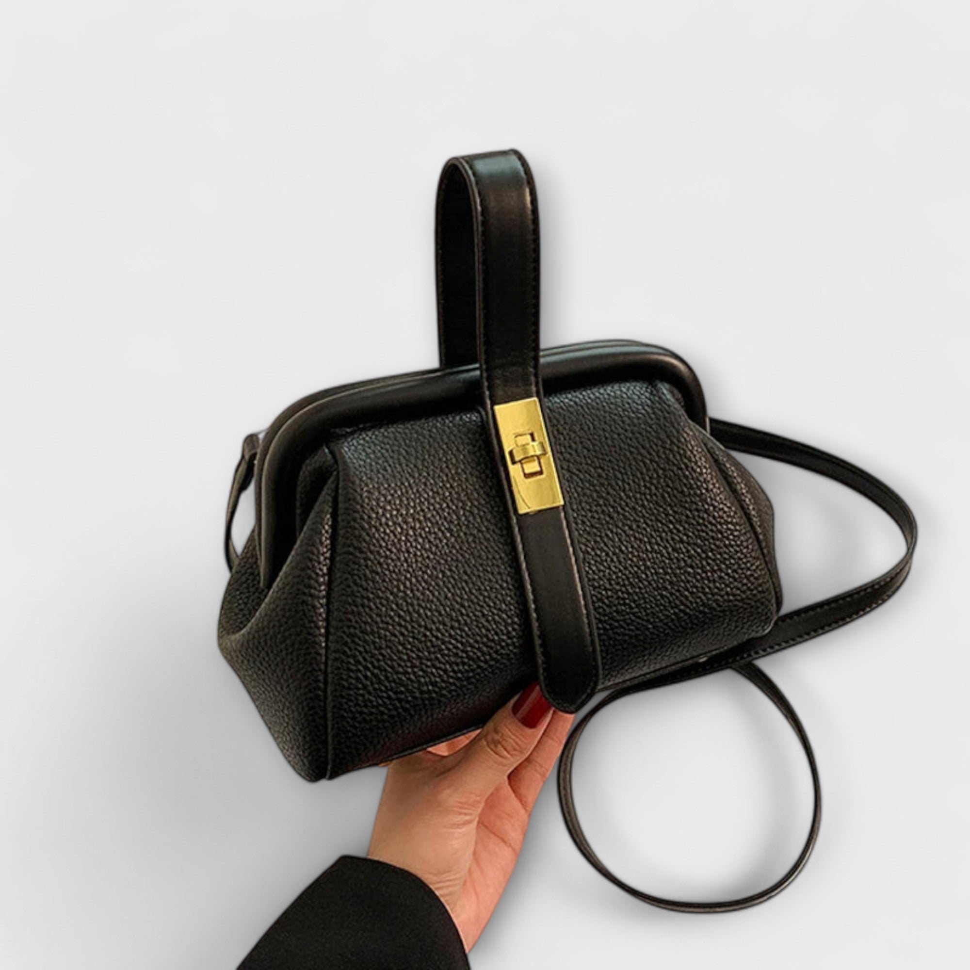 Black textured leather vintage-style crossbody bag with gold front clasp