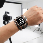 Apple Watch multi-wrap bracelet with braided bands and silver beads, worn on wrist