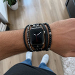 Black multi-wrap watch bracelet with volcanic stone beads and metal clasp on wrist