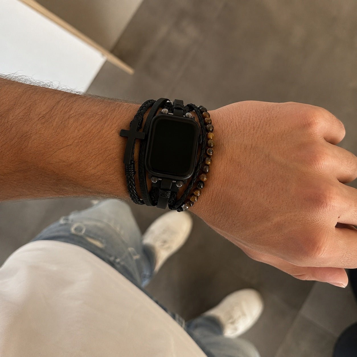 Black multi-row watch band with cross charm and adjustable clasp