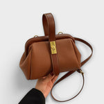 Brown textured leather vintage-style top-handle and crossbody bag with gold clasp