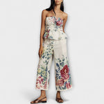 Two-piece floral summer set: strapless peplum top and wide-leg trousers, cream multicolor