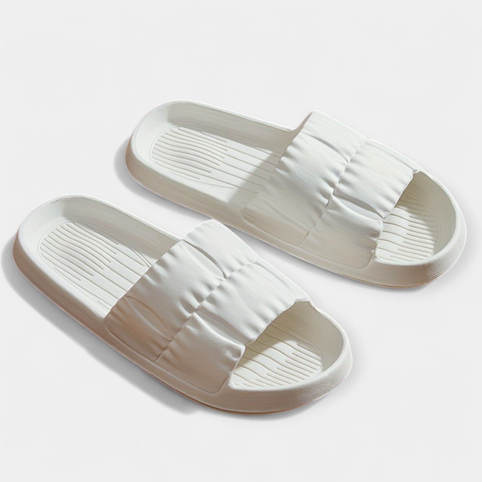 Lightweight slide sandals in light cream, padded strap and ridged footbed, pair view