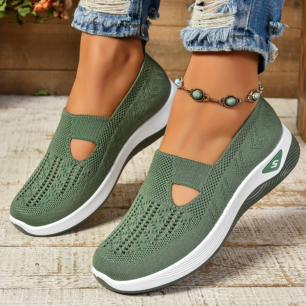 Green orthopedic slip-on sneakers on feet with knit upper and white cushioned sole