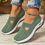 Green orthopedic slip-on sneakers on feet with knit upper and white cushioned sole