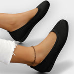 Black knit slip-on ballet flats with rounded toe and textured sole