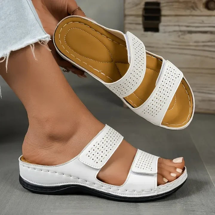 White orthopedic slide sandals with perforated straps and padded insole